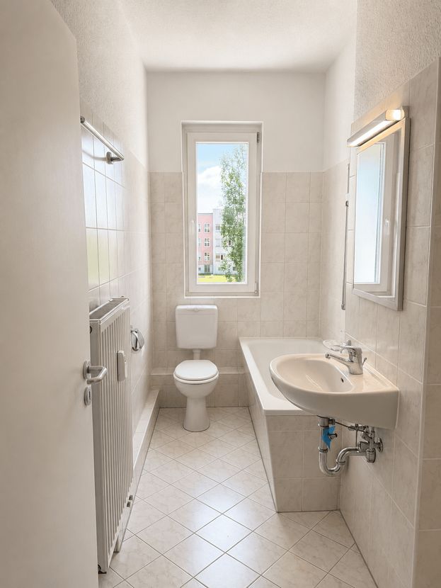 Badezimmer mit Waschbecken und Fenster im Komfort-Apartment Dresden-Reick